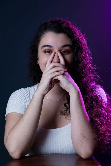 Young Beautiful Woman With Both Hands On Her Lower Face Stock Image