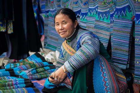 A Blue Hmong Woman Sells Fabrics In The Bac Ha Market Outside Sa