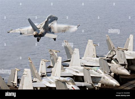 A Us Navy F A 18f Super Hornet Fighter Aircraft Takes Off From The Flight Deck Of The Aircraft