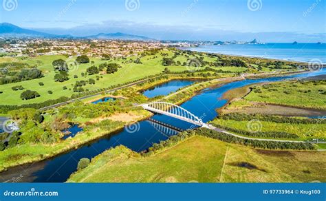 Aerial View On A Beautiful Bridge Across A Small River With Residential