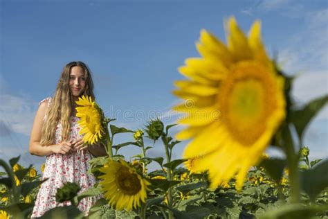 A Lovely Blonde Model Poses Outdoor While Enjoying The Summer Weather In A Field Of Wild