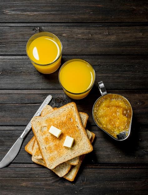 Premium Photo Toasted Bread With Butter Orange Jam And Juice