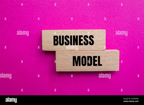Business Model Message Written On Wodoen Blocks With Pink Background