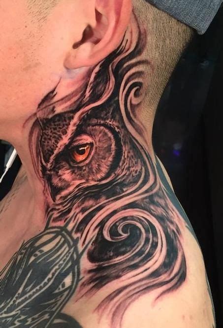 A Man With An Owl Tattoo On His Neck