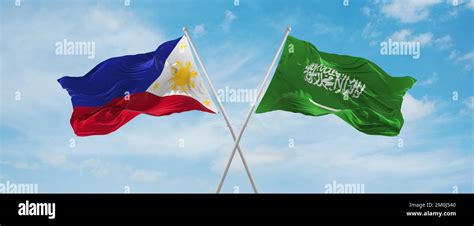 Two Crossed Flags Saudi Arabia And Philippines Waving In Wind At Cloudy