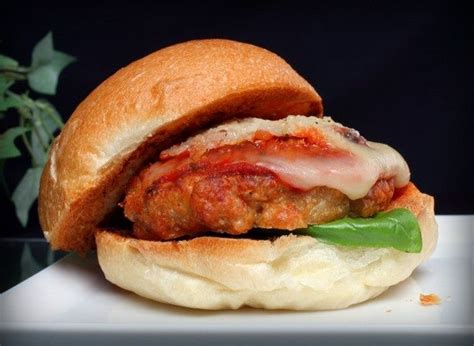 A Meatball Sandwich With Cheese And Tomato Sauce On A Bun Ready To Be Eaten