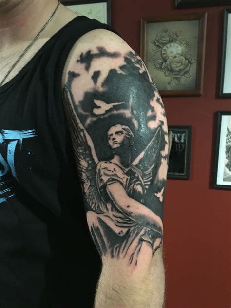 A Black And Grey Angel Tattoo On The Shoulder By Joshua Nordstrom At