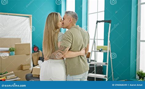 Man And Woman Couple Hugging Each Other Kissing At New Home Stock Image