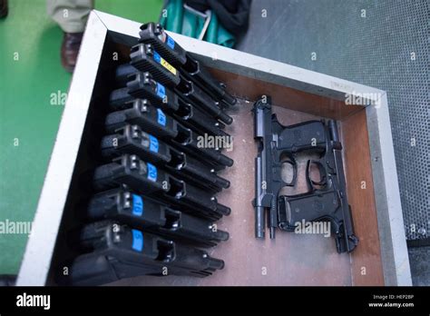 Top View Of A Row Of M11 Sig Sauer P228 9 Mm Pistols And Two M9 Beretta