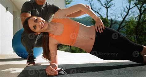 Couple Doing Stretching Exercises Together in front of luxury villa ...