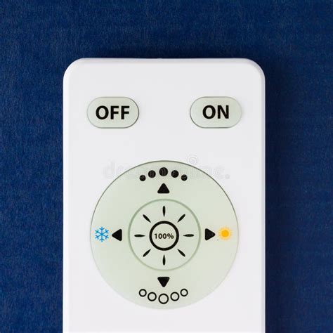 White Remote Control With The Buttons On The Blue Background Stock