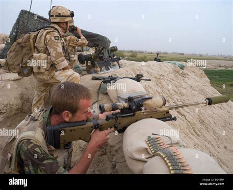 British Army Sniper Looking Through Sight In Helmand Province