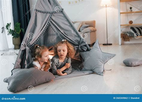 In The Tent Two Children Is Together At Home At Daytime Stock Photo