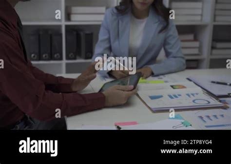 Business Conference Room With People Sharing Documents With Pie Charts