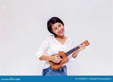 Young Asian Female Girl Playing Ukulele Beach Guitar In White Isolated