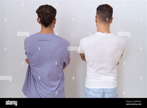 Homosexual Gay Couple Standing Over White Background Standing Backwards Looking Away With