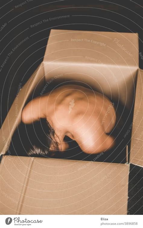 A Naked Woman Huddled In A Box A Royalty Free Stock Photo From Photocase