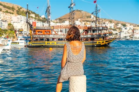 Premium Photo Woman Looking At Tourist Boats At Saranda Beach On The