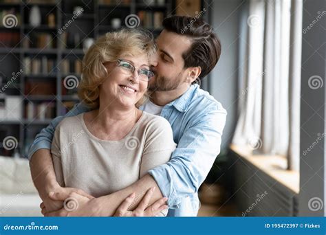 Loving Adult Son Kissing And Hugging Happy Mature Mother Royalty Free