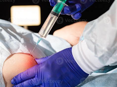The doctor injects an anti-inflammatory drug into the shoulder joint to