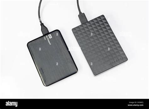 Westren Digital And Seagate Portable External Hard Drive Connected With A Cable With Computer