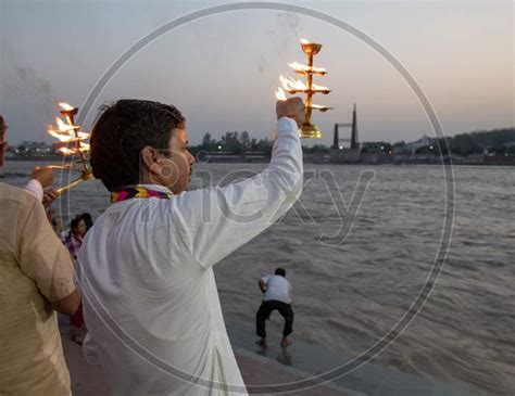 Image Of Priest Performing Haarthi Or Aarthi To Holy River Ganges In