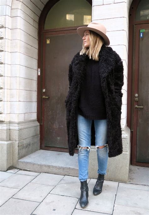 Black Faux Fur Coat Over Black Sweater And Jeans Winter Outfits