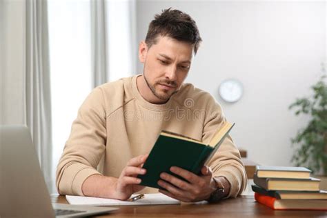 Man Reading Book at Table in Library Stock Photo - Image of public ...