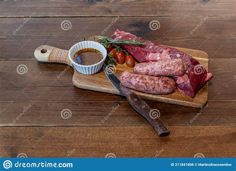 Argentine Cut Of Meat Called Vacio With Chorizos And Chimichurri Stock