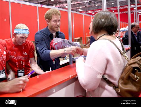 Prince Harry Helps Staff Hand Out Race Numbers And Headbands As He