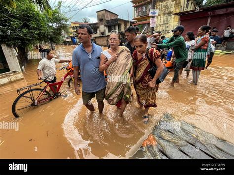 October People Cross A Waterlogged Road After Heavy Rainfall