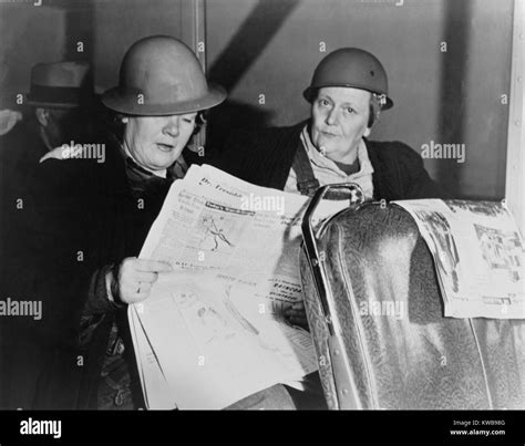 After Working All Night Two Helmeted Women Shipyard Workers Read The