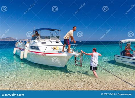 Pleasure Motor Boat With Passengers And Crew On The Beach Editorial