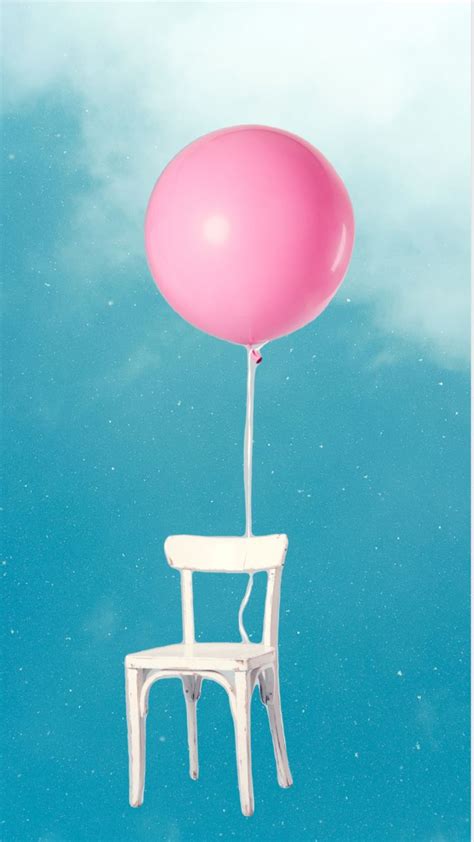 A White Chair Floating In The Air With A Pink Balloon Attached To It