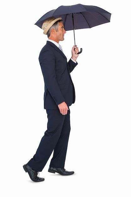 Premium Photo Businessman In Straw Hat Under Umbrella