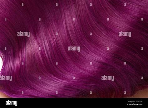A closeup view of a bunch of shiny straight purple hair in a wavy ...