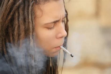 Young boy smoking weed on light background Stock Photo by ©belchonock ...