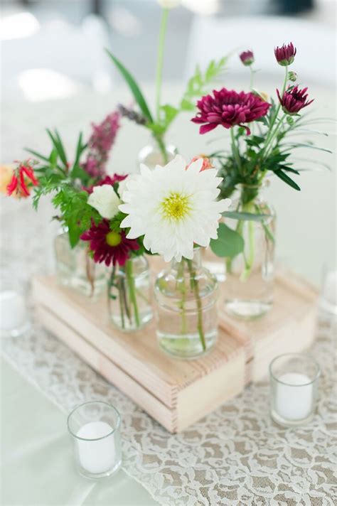 Assortment of Glass Vase Flower Arrangements on Wood Crates