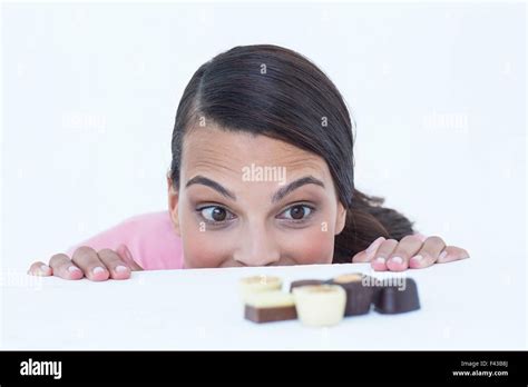 Pretty Brunette Peeking At Chocolate Stock Photo Alamy