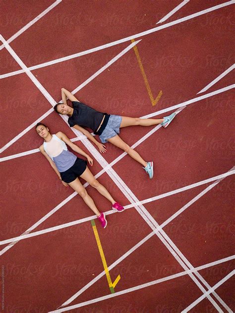 Female Athletes Resting Between Exercises By Stocksy Contributor MEM