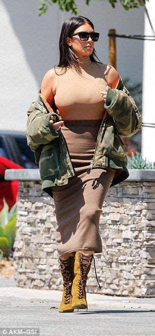 Kim Squeezes Her Ample Assets Into A Skin Tight Bodysuit And Skirt