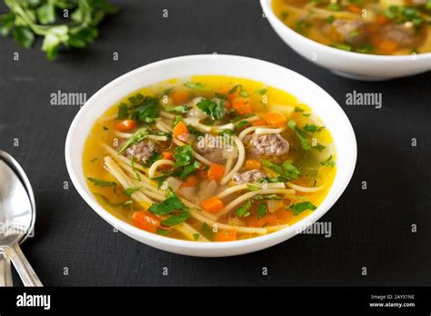 Homemade Sopa A La Minuta In White Bowls On A Black Background Low