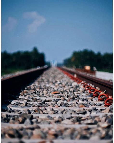 the train tracks are lined with rocks and red chains on each side, as ...