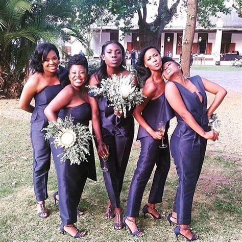 A Group Of Women Standing Next To Each Other On Top Of A Grass Covered