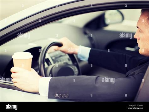 Man Drinking Coffee While Driving The Car Stock Photo Alamy