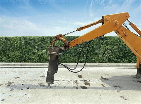 Excavator Breaking And Drilling The Concrete Road For Repairing Large