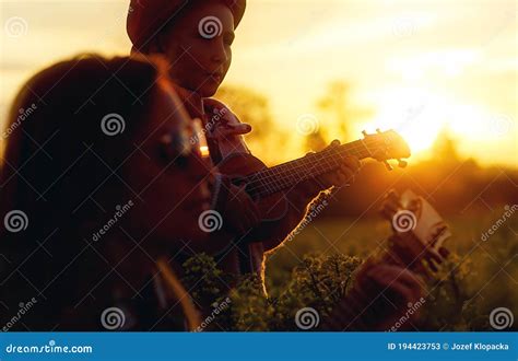 Mother With Daughters Playing With Guitar And Ukulele Stock Image