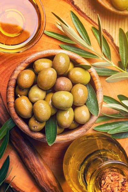 Premium Photo Green Olives Oil And Leaves