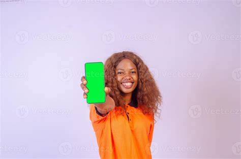 Beautiful Black Girl Shows Her Phone Screen While Feeling Happy And