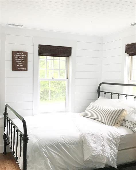 Simple White Farmhouse Bedroom With White Shiplap And Black Metal Bed